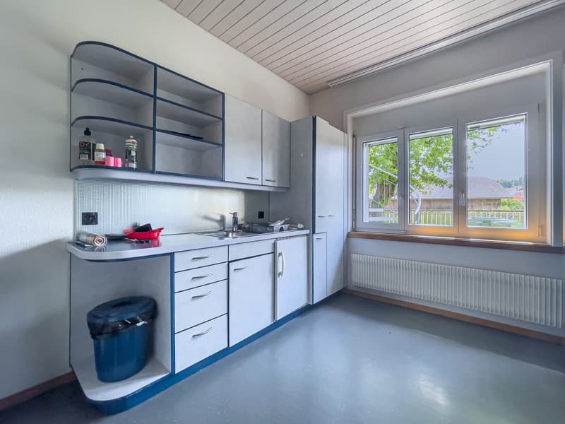 kitchen with modern cabinets, sink, dishwasher, washing machine and fridge