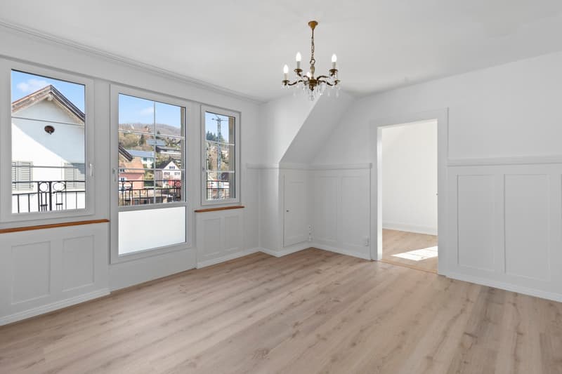 empty room, wooden floor, white walls, chandelier, large windows, balcony