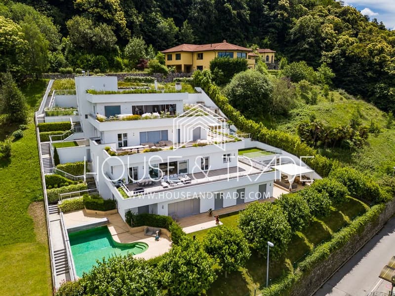 3-story house with a swimming pool, terrace, green roofs, and multiple terraces with outdoor seating.