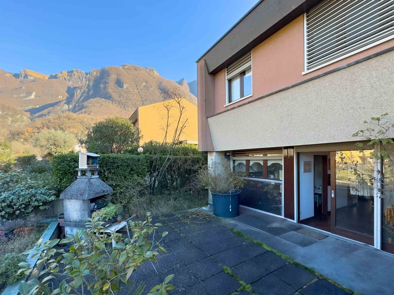 House with a garden, a fireplace, and a view of the mountains
