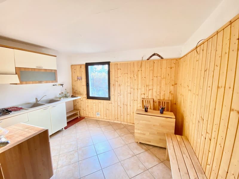 open kitchen with wood floor, wooden bench, window, countertop, sink, gas stove, oven, wooden cabinets