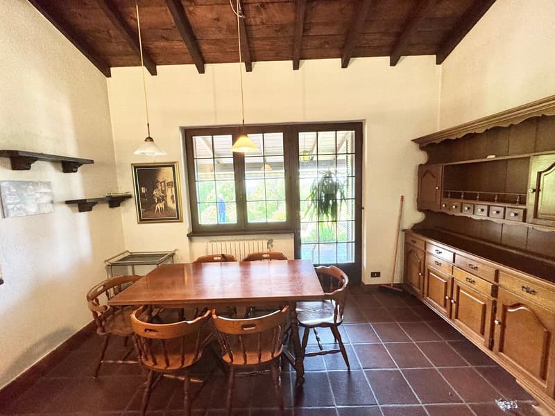 Wooden dining table, six wooden chairs, glass doors, picture frame, shelves, radiator, wooden cupboards