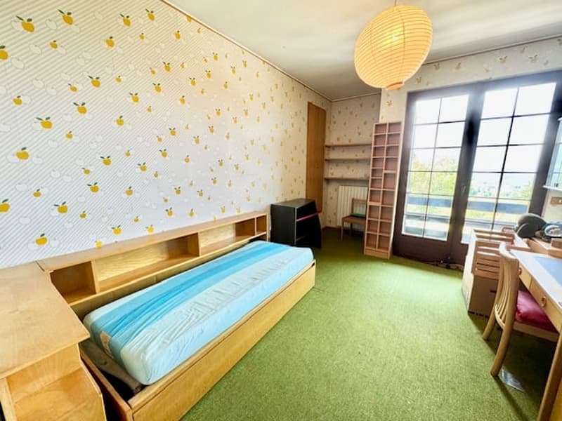 bedroom with wooden bed, desk, chair, shelf, lamp, radiator, carpet