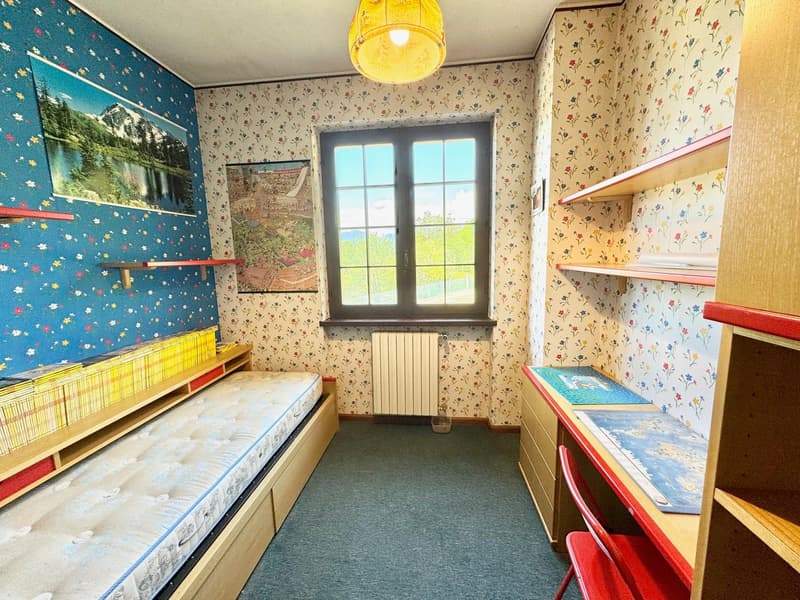 Single bed, bookshelves, desk, chair, window, wallpaper, radiator
