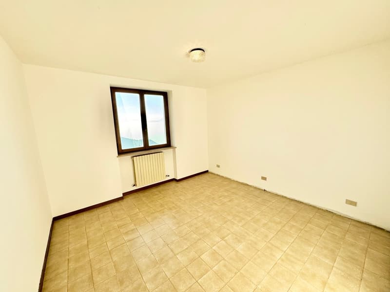 empty room, tiled floor, white walls, radiator, single window