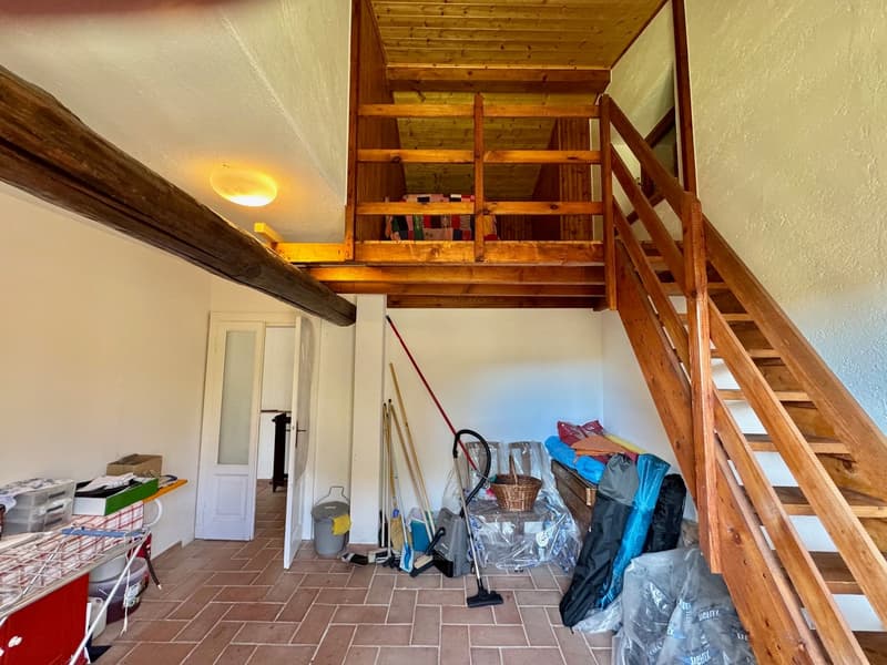 room with wooden staircase, storage boxes, cleaning tools, plastic sheet