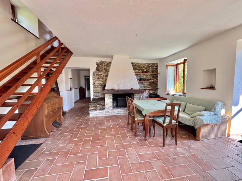 stone fireplace, dining table, chairs, sofa, staircase, tiled floor