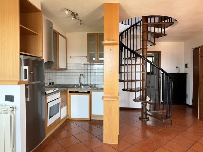 kitchen with tile flooring, wooden cabinets, spiral staircase, gas stove, sink, refrigerator, dishwasher, cabinets