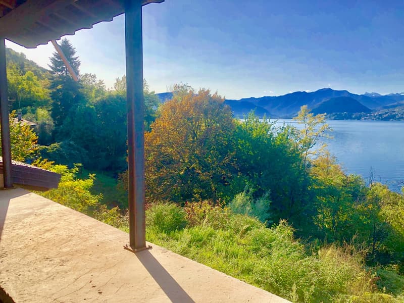 wooden railing, gravel floor, lake view, mountain view, trees, grass