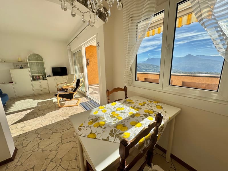 dining room, glass table, dining chairs, buffet, chair, television, curtains, chandelier, terrace, view of mountains