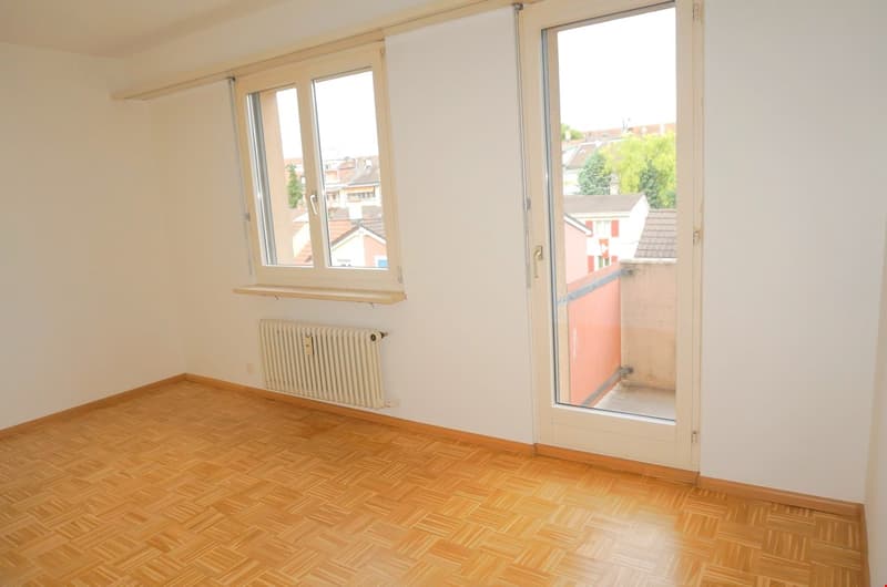 empty room, wooden floor, white walls, two windows, sliding door to balcony