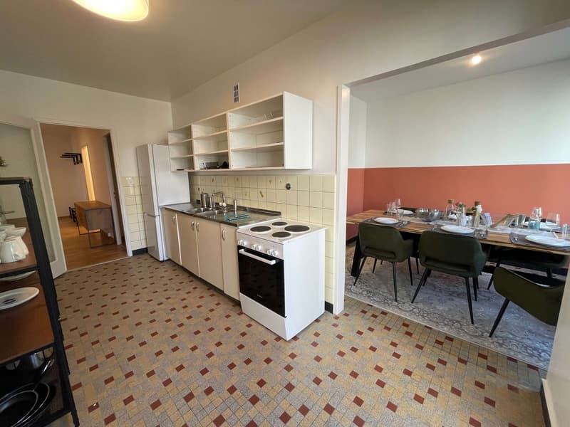 kitchen with dining area, white appliances, tiled floor, dining table, chairs, shelves, wooden cabinet