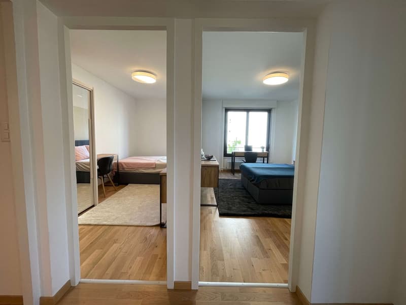 Two bedrooms with beds, desks, chairs, and a window with a view outside.