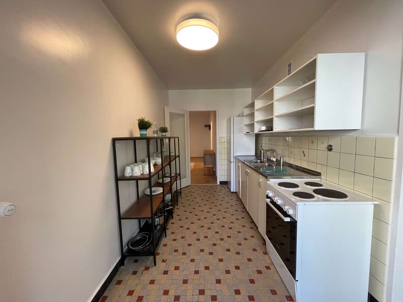 kitchen with white appliances, tiled floor, white cabinets, ceiling light, open door