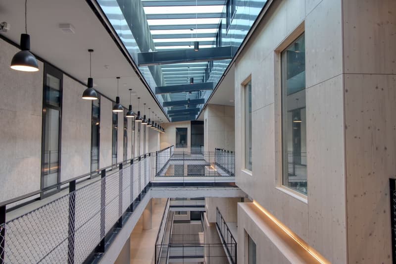 multi-story building, glass ceiling, metal railings, multiple balconies