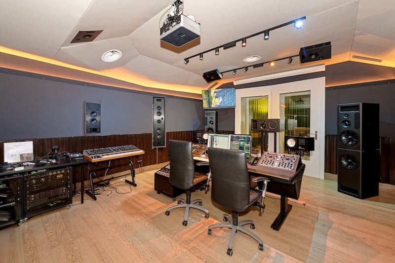 wooden floor, recording studio setup with desks, equipment, keyboards, speakers, projector, monitors
