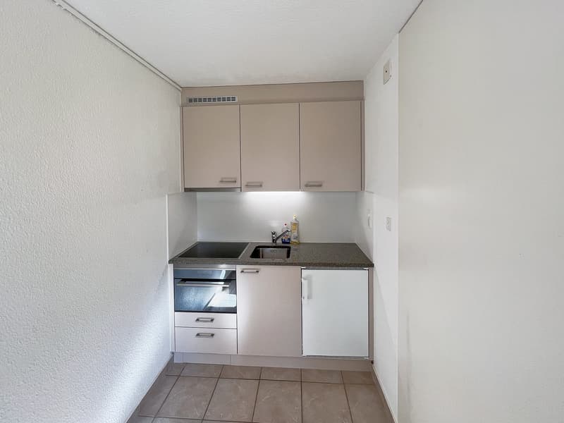 modern kitchen with white cabinets, granite countertop, sink, oven, dishwasher, washing machine