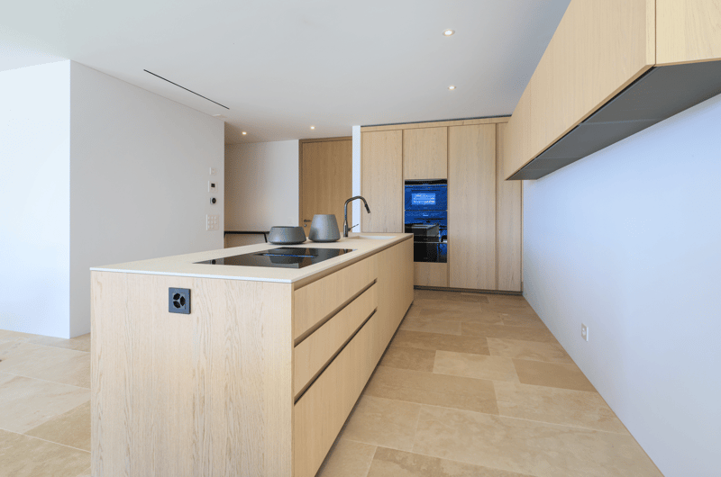 modern kitchen with wooden cabinets, tiled floor, induction stove, sink, faucet, built-in oven