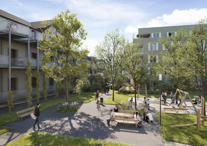 Community courtyard with people and benches, surrounded by trees and plants
