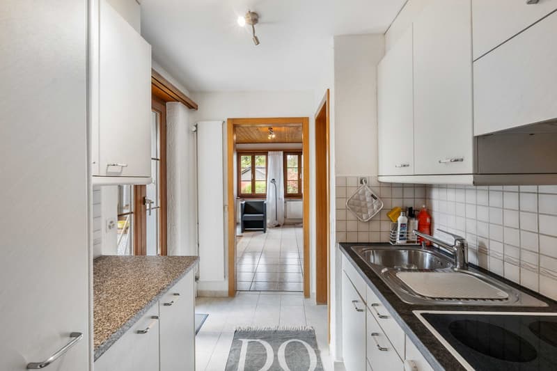 kitchen with granite countertops, modern cabinets, stainless steel sink and faucet, dishwasher, washing machine