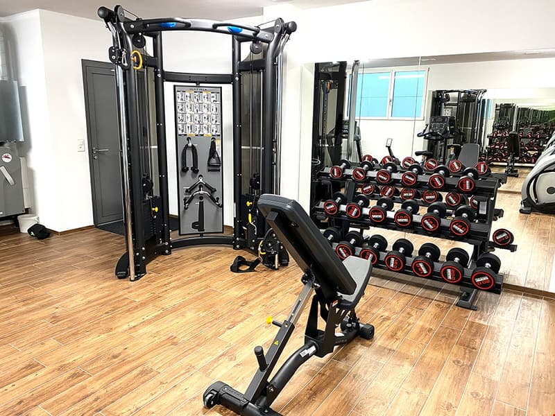 home gym with weights, weights rack, gym equipment, mirrored wall