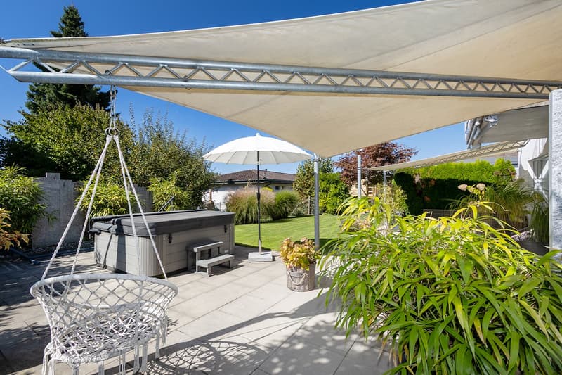 outdoor umbrella, hot tub, white hanging chair, terrace with large canopy