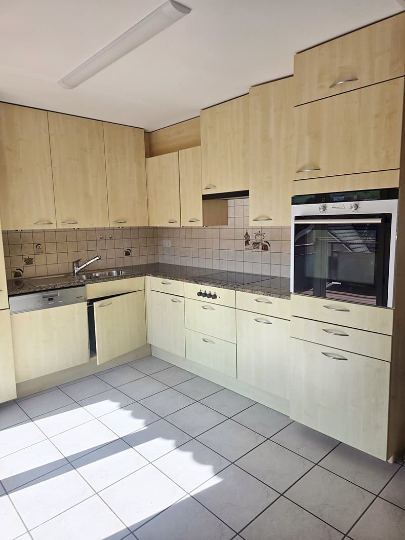 modern kitchen with wooden cabinets, granite countertops, stainless steel sink, dishwasher, oven, tiled floor