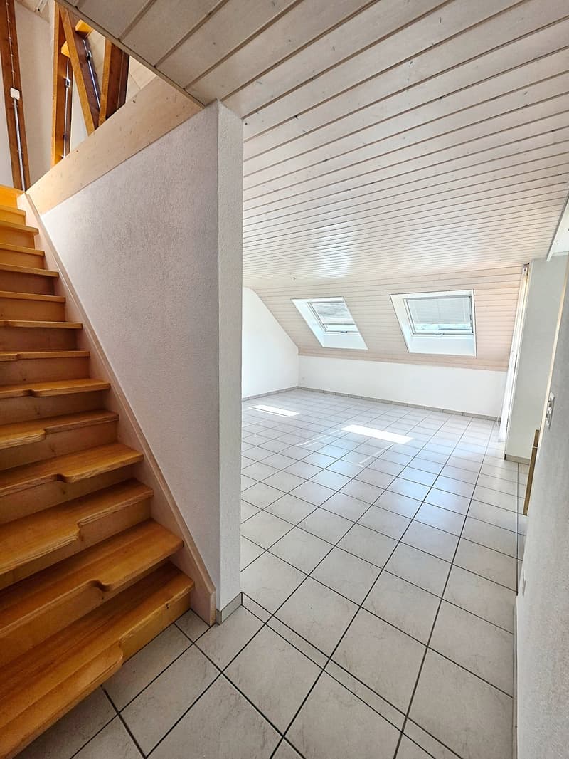 empty room, white tiled floor, wooden stairs, two attic windows
