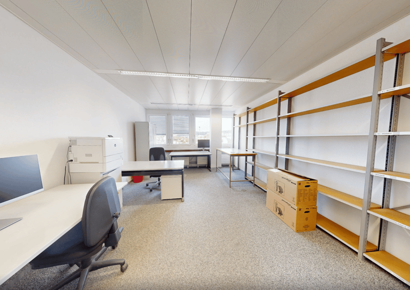 empty room with desks, chairs, cabinets, shelves, carpeted floor, open door