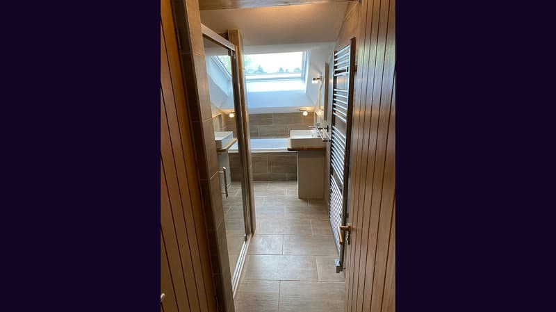 tiled floor, bathtub, vanity, wooden doors, skylight