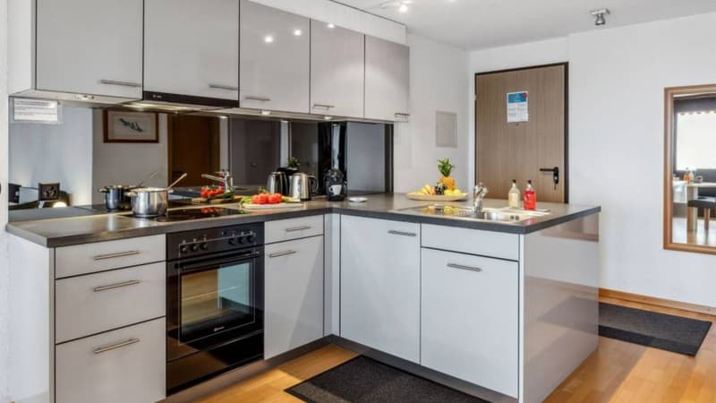 modern kitchen, white cabinets, stainless steel appliances, granite countertop, sink, oven, dishwasher, refrigerator, microwave, coffee maker, toaster, blender, food processor, wine cooler, wine rack, wine glasses, bar stools, dining table, chairs, pictur