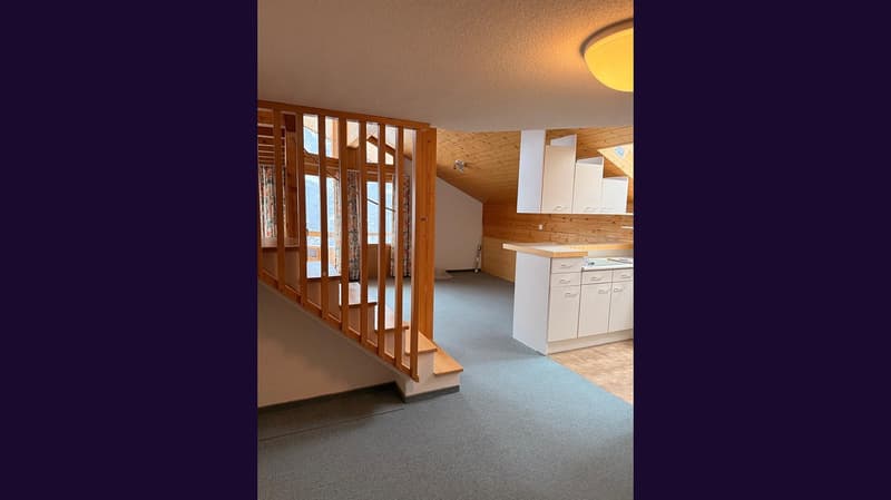 wooden staircase, carpeted floor, wooden ceiling, kitchen with white cabinets, windows with curtains