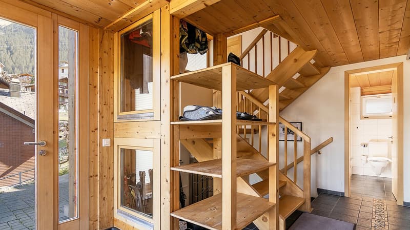 wooden walls, wooden stairs, wooden shelves, glass doors, ski equipment