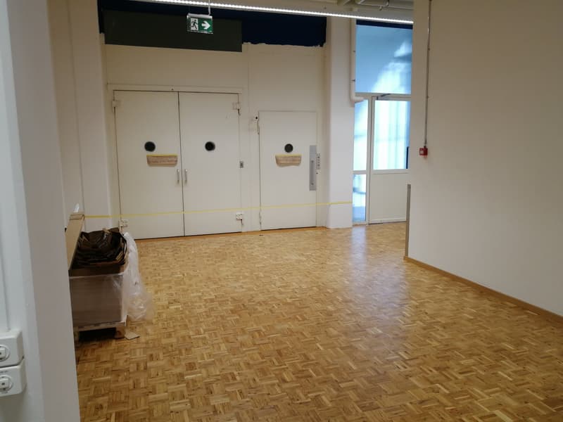 empty room, wooden floor, white walls, two large doors, yellow caution tape