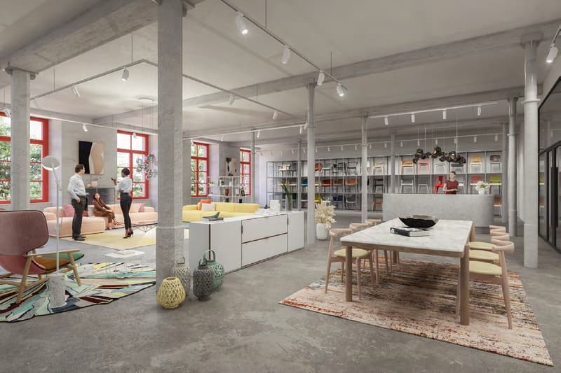 Modern, open-plan space with seating areas, dining table, bookshelves, artwork, carpeted floors, exposed beams, large windows