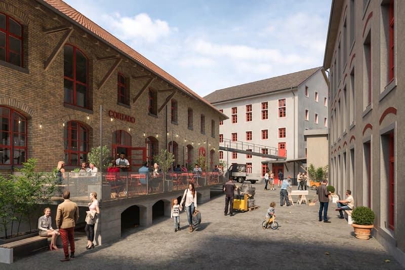 Industrial building complex, multiple red windows, outdoor seating area, central open space