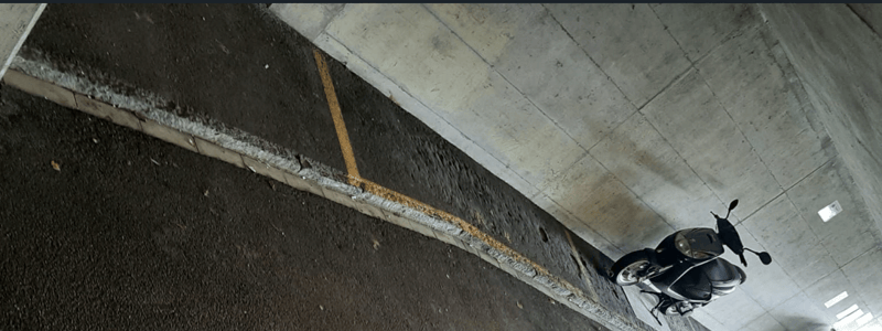 underground parking lot, yellow markings, grey concrete ceiling