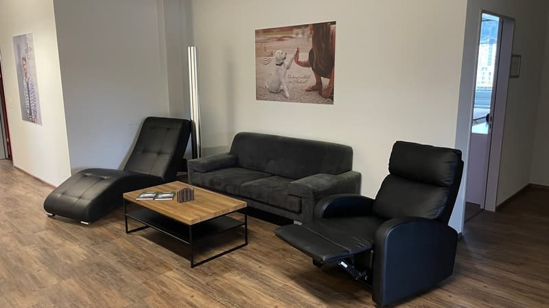 Living room with a couch, two recliners, a coffee table, and a picture on the wall.