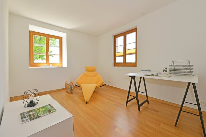 empty room, white walls, hardwood floors, windows, desk, chair