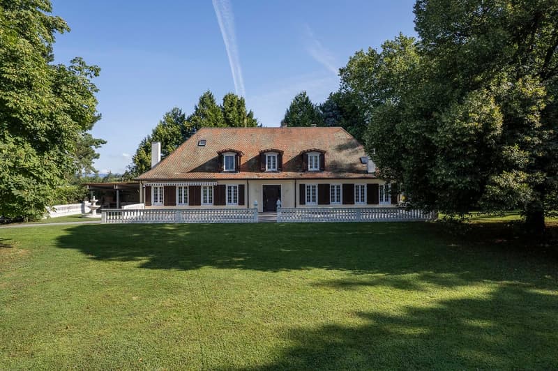 2 story house, red brick, white windows, raised ground floor, chimney, garden, lawn