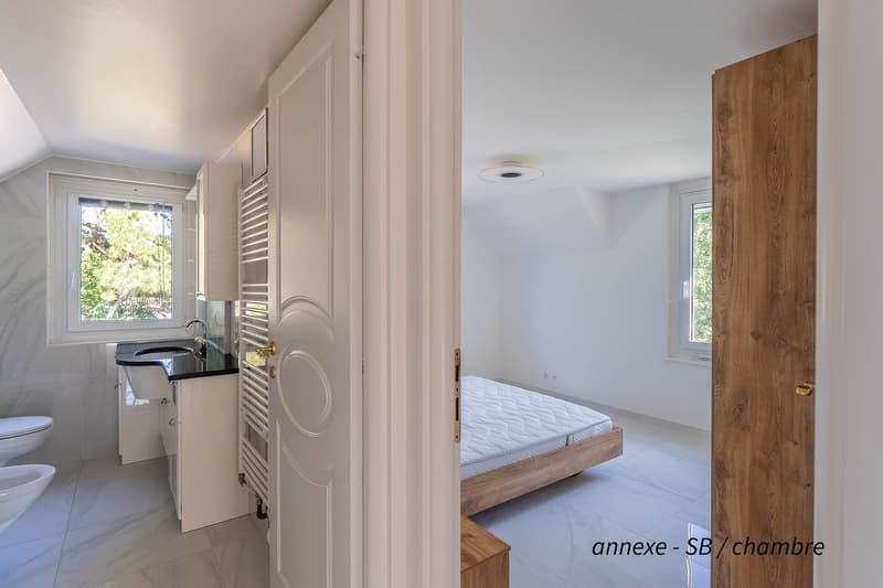 modern bathroom with toilet and sink, separate sleeping area with a double bed