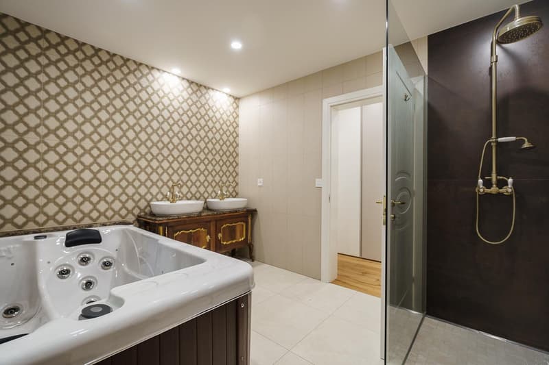 bathroom with walk-in shower, jacuzzi tub, 2 sinks, glass wall