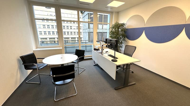 modern office interior with a desk, 3 chairs, round table, windows, monitors, plant