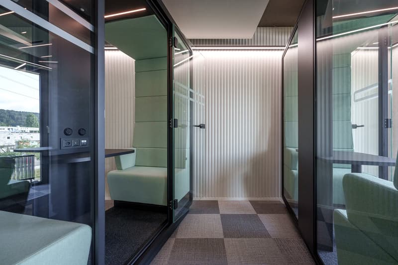 glass walls, green chairs, checkered floor, control panel, small table