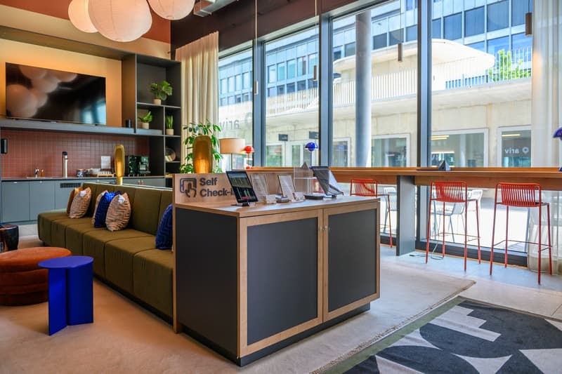 Open layout, modern furniture, glass walls, outdoor view, bar area, couch, lamps, TV