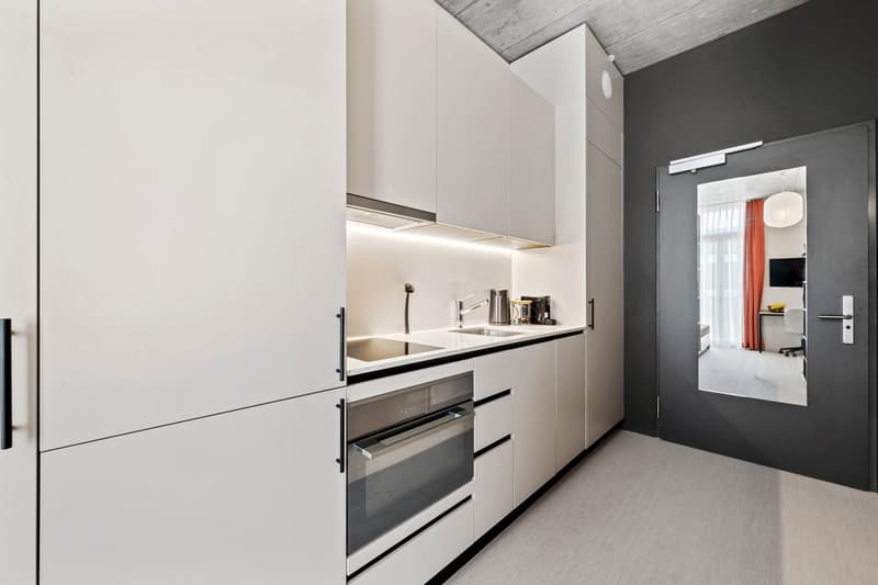 kitchen area with sink, faucet, dishwasher, oven, modern cabinets