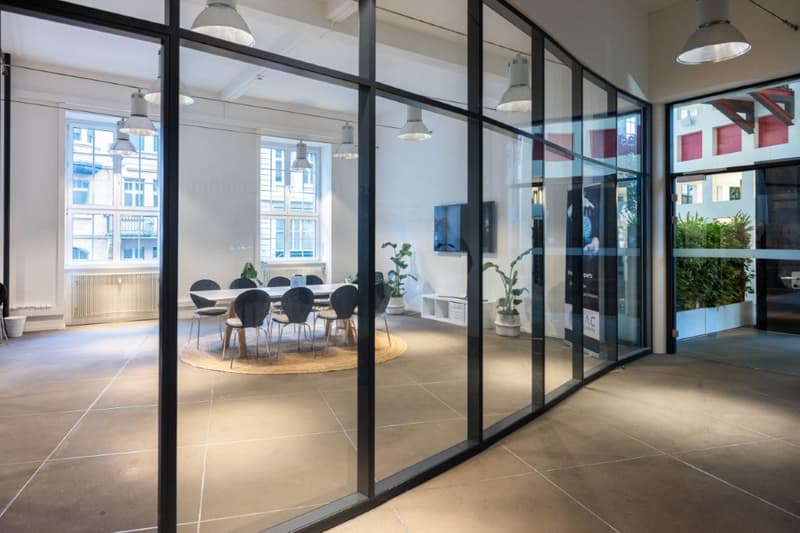 glass walls, wooden floor, long table, chairs, large windows, modern lamps