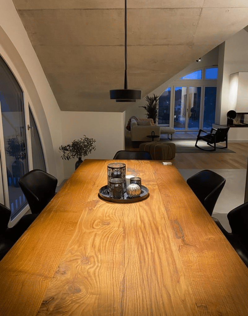 wooden table, 6 chairs, wooden floor, large windows, chandelier, indoor plants