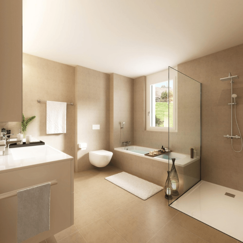 Contemporary bathroom with beige tiles, a bathtub, a shower, toilet, sink, towels, a lamp, a plant