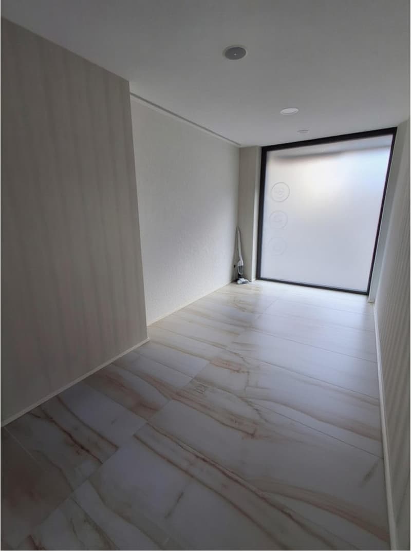 Marble tiles flooring, white walls, large glass panel, empty room